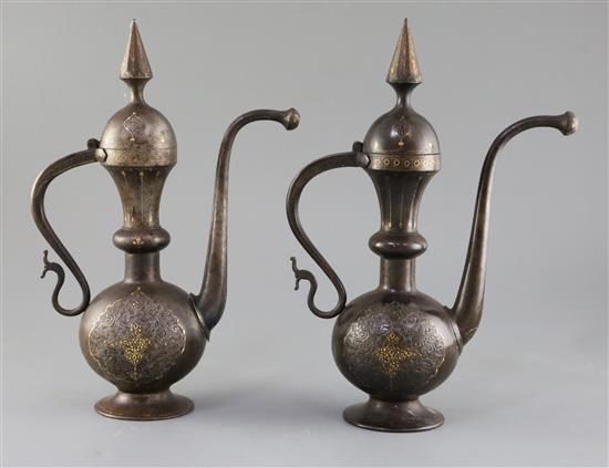 A pair of 19th century Qajar gold inlaid iron rosewater sprinklers, H.12.5in.